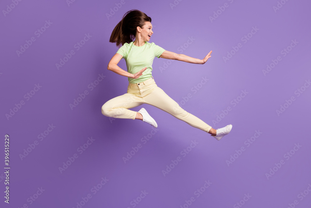 Full length body size view of her she nice attractive pretty lovely funky cheerful girl jumping having fun dancing fighting fooling isolated bright vivid shine vibrant lilac violet color background