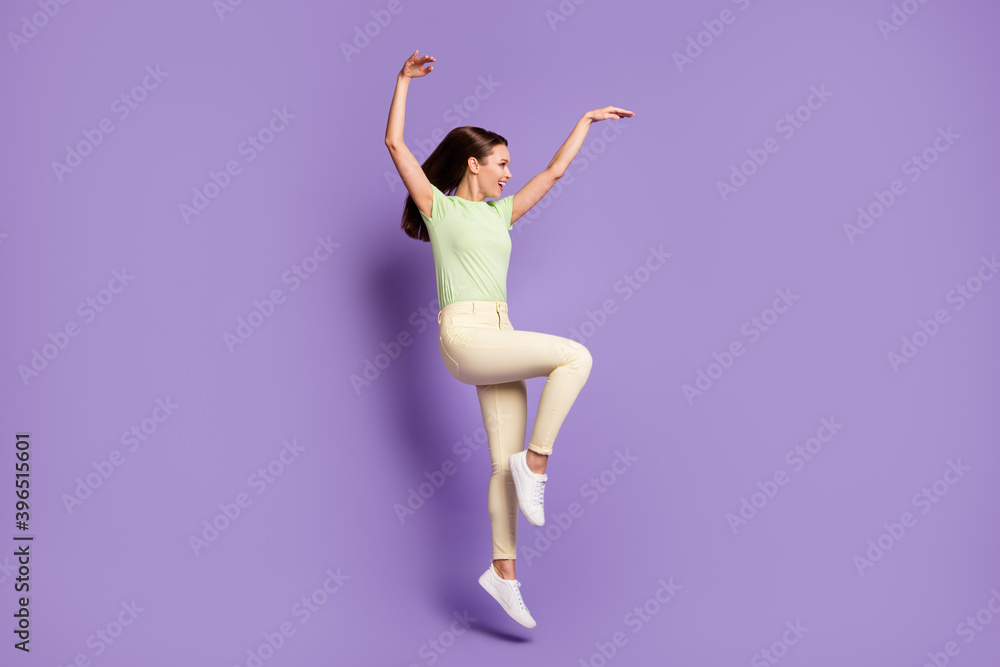 Obraz premium Full length body size profile side view of nice-looking attractive cheerful funky girl jumping dancing modern move having fun isolated bright vivid shine vibrant lilac violet color background