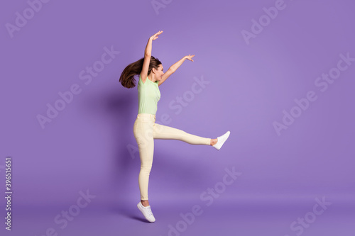 Full length body size profile side view of nice attractive cheerful cheery funky sporty girl jumping dancing professional move isolated bright vivid shine vibrant lilac violet color background