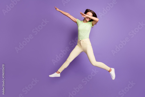 Full length body size view of her she nice attractive pretty cheerful cheery funky girlish girl jumping having fun dancing showing dab isolated bright vivid shine vibrant lilac violet color background