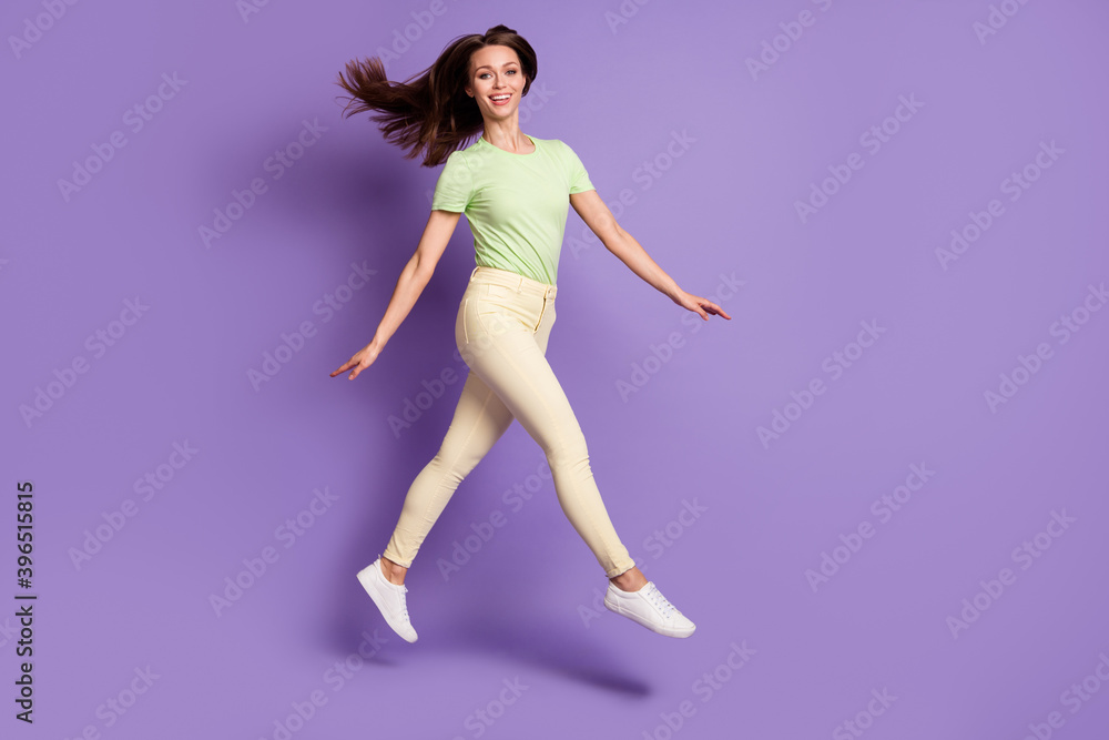 Full length body size view of her she nice attractive lovely cheerful cheery funky slender girl jumping going having fun isolated bright vivid shine vibrant lilac violet color background Full length body size view of her she nice attractive lovely cheerful cheery funky slender girl jumping going having fun isolated bright vivid shine vibrant lilac violet color background