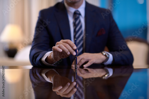 corporate businessman at luxury office pen holding