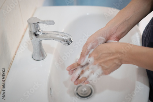 Woman washing hands, Corona virus travel prevention wash hands with soap and hot water. Hand hygiene for coronavirus outbreak. Protection by washing hands frequently concept