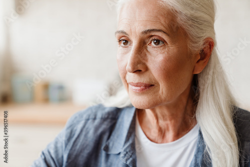 Close up portrait a pensive senior woman thinking