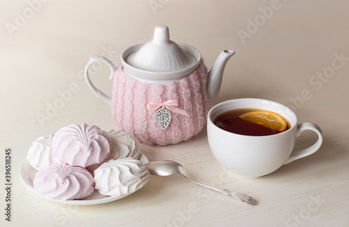 Teapot, cup of tea and marshmallows