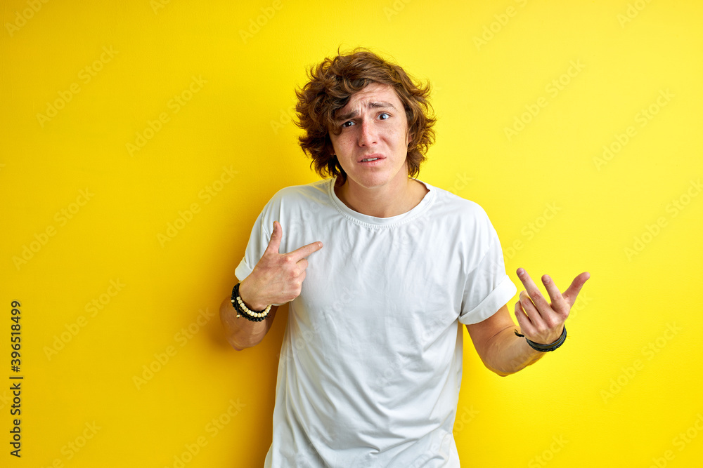 displeased unhappy man pointing on himself, surprised. isolated yellow background displeased unhappy man pointing on himself, surprised. isolated yellow background