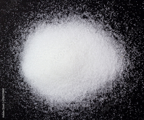 Piles of white sugar flattened as food or seasoning, sweet taste, risk of diabetes, use as background image.