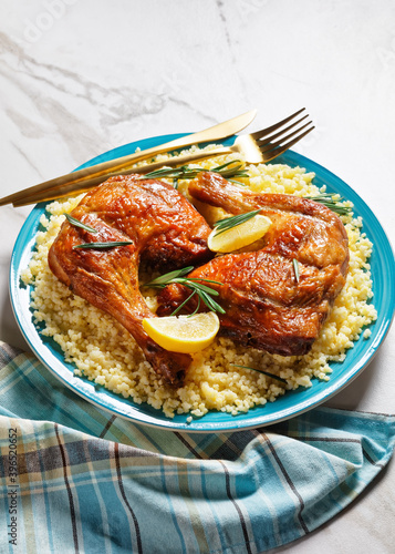 Chicken leg quarters over the millet on a plate