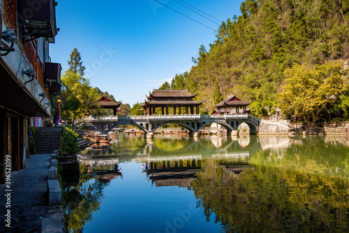 the river, the boat, stone bridge and the old houses at ancient phoenix town in the morning at Hunan, China. 