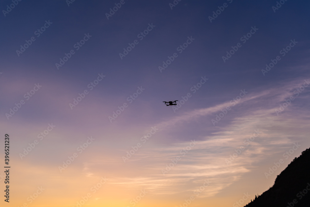 Drone flying above Iseo Lake at sunset