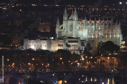 La iglesia de Palma de Mallorca y el palacio de la Almudaina iluminados de noche photo