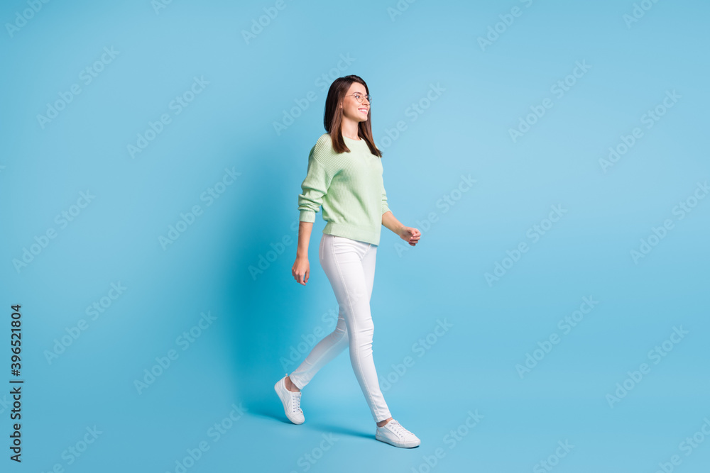 Full body profile side photo of pretty girl go empty space isolated over blue color background