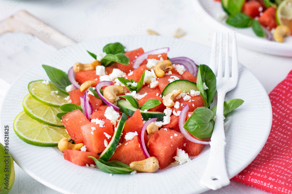 Watermelon salad with basil, mint, red onion, cucumber and cashew nuts Watermelon salad with basil, mint, red onion, cucumber and cashew nuts