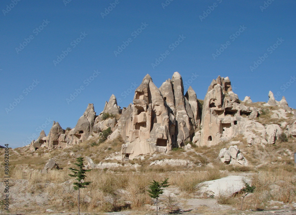 Panorama of a mountain valley covered with rocks of unusual shapes on a background of sunny blue sky over the horizon. Panorama of a mountain valley covered with rocks of unusual shapes on a background of sunny blue sky over the horizon.