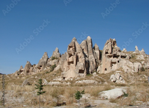 Panorama of a mountain valley covered with rocks of unusual shapes on a background of sunny blue sky over the horizon.