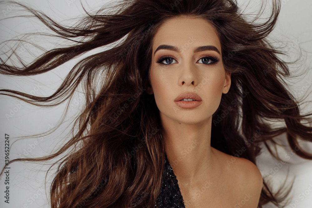 Naklejka premium Close-up photo portrait young woman with hair blowing in air beautiful make-up isolated white color background