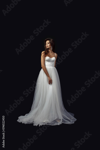Full length body size photo of young girl in white wedding dress luxury earrings looking at side isolated on dark color studio background