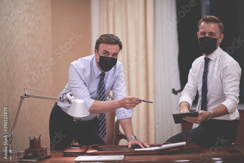 business people wearing crona virus protection face mask on meeting photo