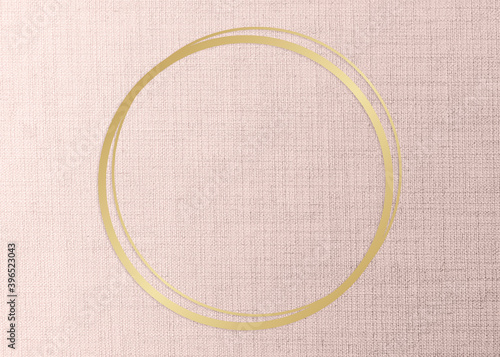 Gold round frame on a peach fabric background