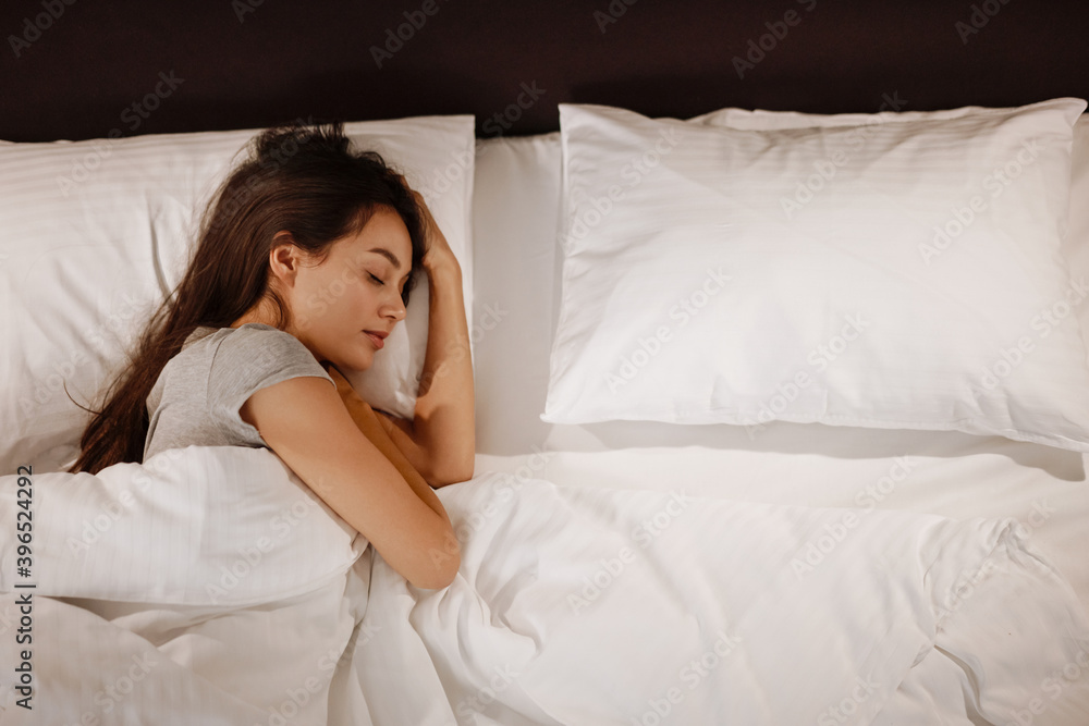Brunette beautiful caucasian woman sleeping in bed at home Brunette beautiful caucasian woman sleeping in bed at home