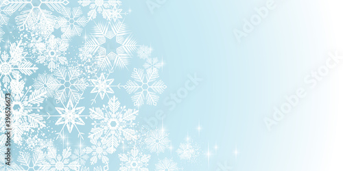 White winter snowflakes on a blue background - Merry Christmas and winter snow design banner