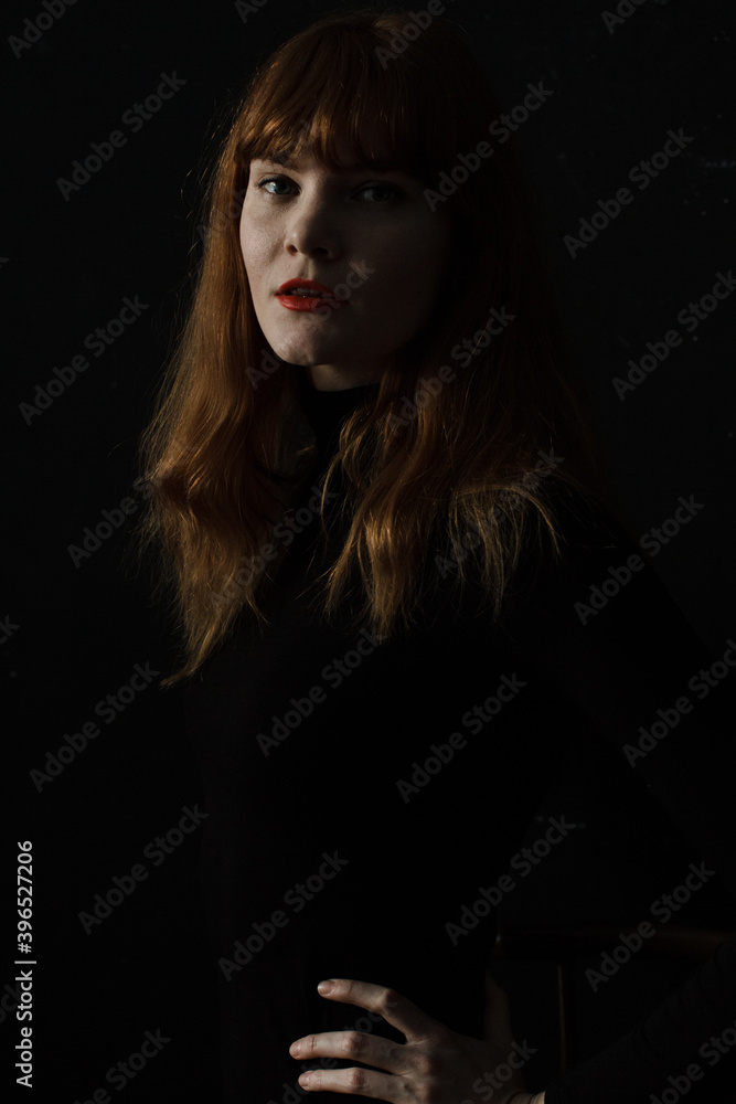 Portrait of ginger woman with red lips in black dress Portrait of ginger woman with red lips in black dress