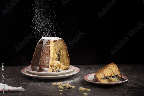 Delicious Pandoro with chocolate filling covered with powder