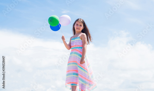 Young and free. summer holiday and vacation. freedom. beautiful teen girl. kid fashion style. female natural beauty. happy childhood. cute child on sky background with balloons. spring season weather