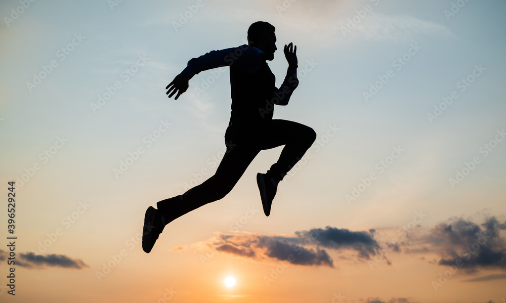 man runner silhouette running to future against sunset sky, success
