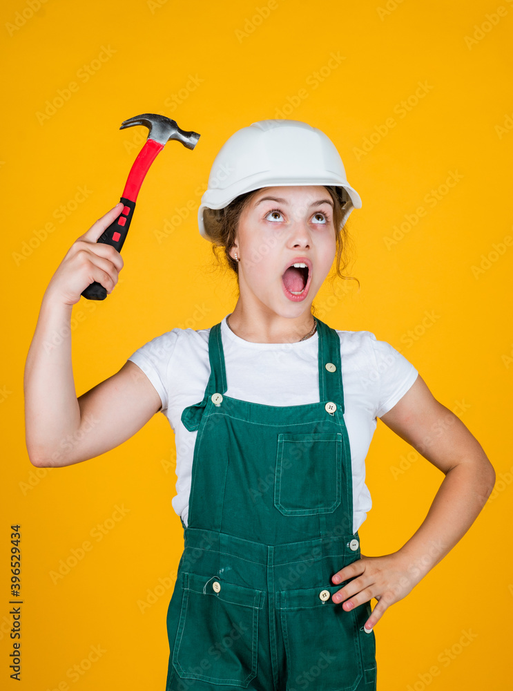 Smart professional. future engineer. happy kid use hammer repairing tool. building construction site. child architect worker. labor day concept. childhood development. teenager girl assistant Smart professional. future engineer. happy kid use hammer repairing tool. building construction site. child architect worker. labor day concept. childhood development. teenager girl assistant