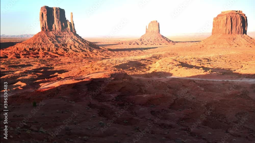 Aerial view of car traffic across the monument valley at sunset, time lapse