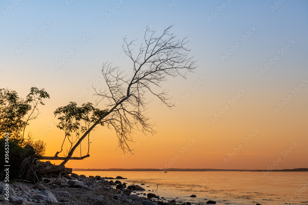Sunset at the rocky Baltic Sea coast with mirror-smooth sea. Sunset at the rocky Baltic Sea coast with mirror-smooth sea.