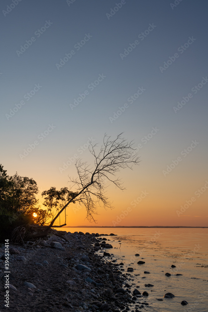 Sunset at the rocky Baltic Sea coast with mirror-smooth sea. Sunset at the rocky Baltic Sea coast with mirror-smooth sea.