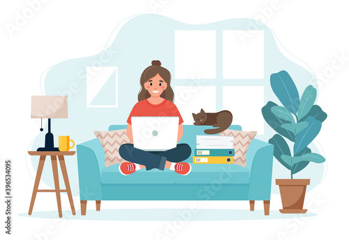 Home office concept, woman working from home sitting on a sofa, student or freelancer.