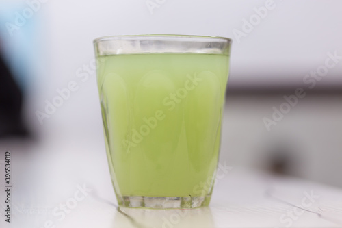 a glass of fresh green drink on the table
