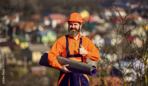 Master of building at work. builder installing roof tile. construction work with felt. roof industrial. Roofer contractor laying rooftop with protective helmet. man roofer inspecting damaged roof