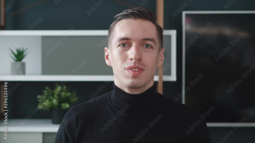 Webcam view of pleasant smiling young business man talk to camera make online video conference call at modern home office. Webcam view of pleasant smiling young business man talk to camera make online video conference call at modern home office.