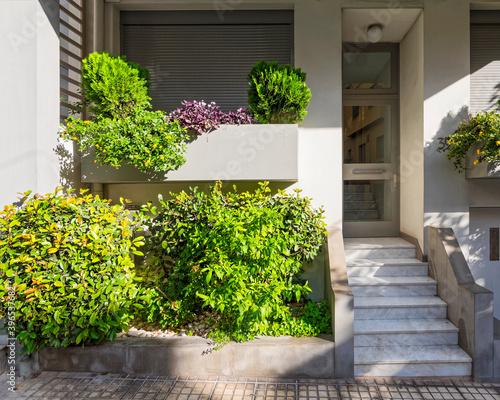 modern family house front with stairs, plants and entrance door, Athens Greece