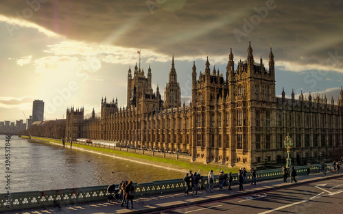 Fototapeta London England, the British parliament and Thames river under dramatic sky