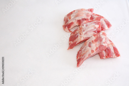 Raw meat, uncooked pork ribs on a white background.