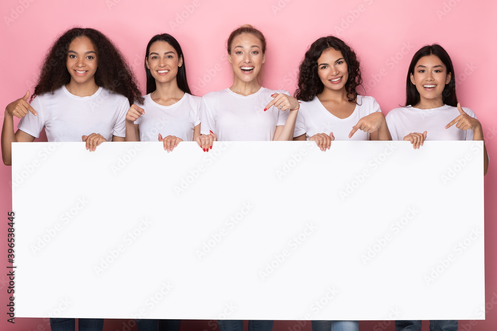 Women Holding Empty Paper Board Standing Over Pink Studio Background Women Holding Empty Paper Board Standing Over Pink Studio Background
