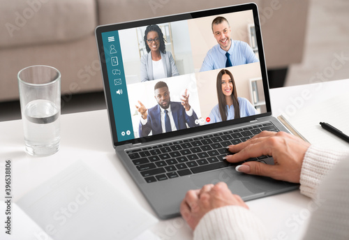 Unrecognizable lady having online conference with her business partners