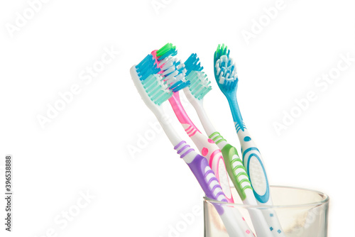 Toothbrushes in glass isolated on white background