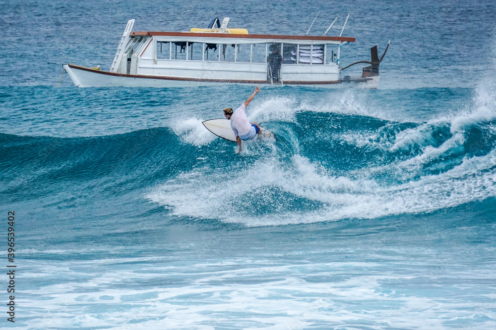 Obraz premium Surfer on perfect blue aquamarine wave, empty line up, perfect for surfing, clean water, Indian Ocean