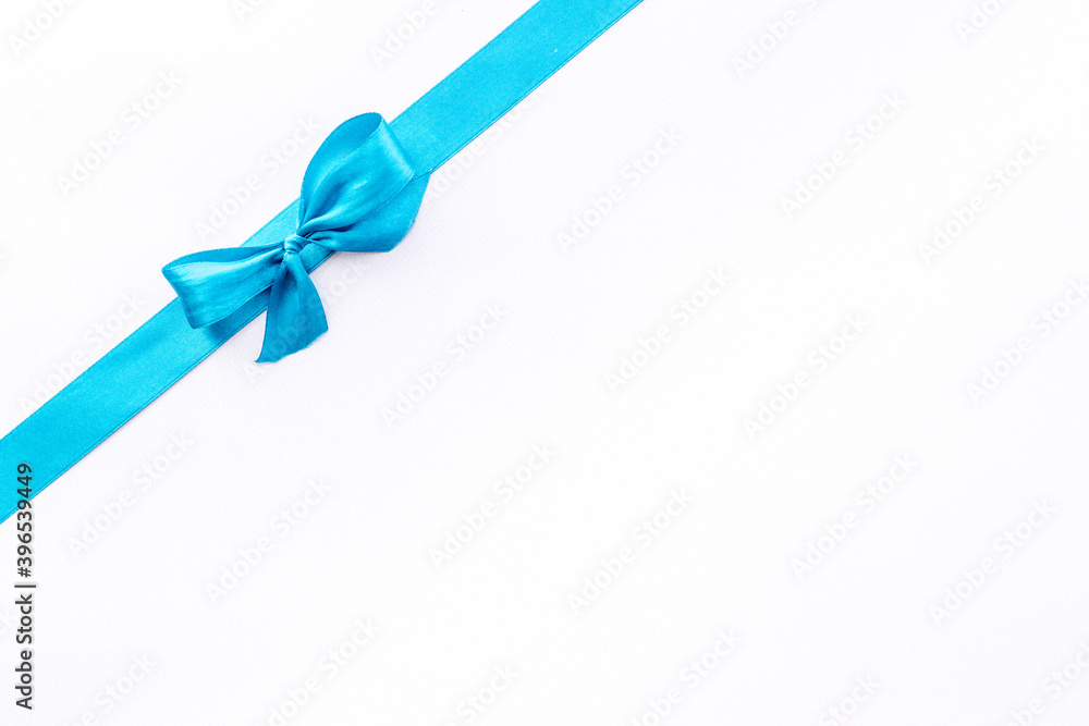 Blue ribbon with bow isolated on white. Top view, copy space Blue ribbon with bow isolated on white. Top view, copy space
