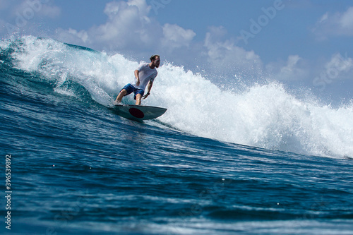 Surfer on perfect blue aquamarine wave, empty line up, perfect for surfing, clean water, Indian Ocean © Lila Koan
