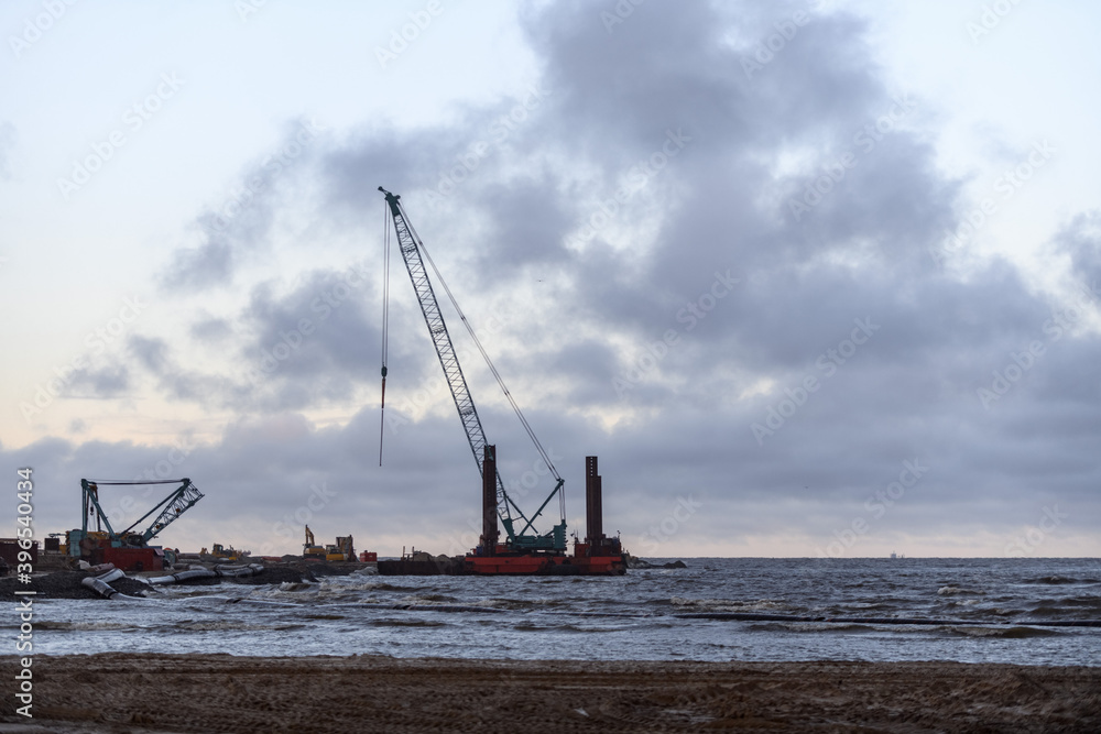 Construction Marine offshore works. Dam building, crane, barge, dredger. Breakwater construction. Construction Marine offshore works. Dam building, crane, barge, dredger. Breakwater construction.