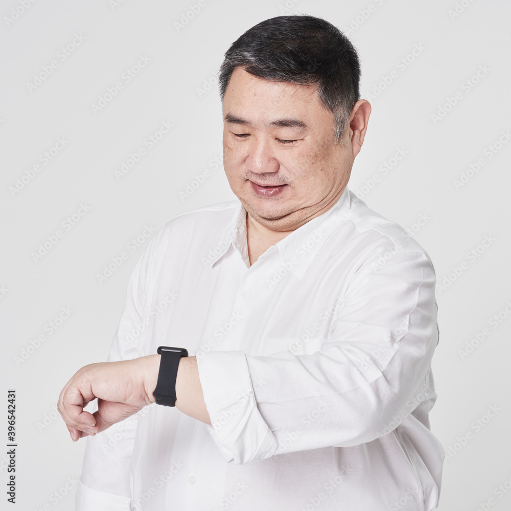 Plus size men's white shirt with hand watch fashion shoot in studio Plus size men's white shirt with hand watch fashion shoot in studio