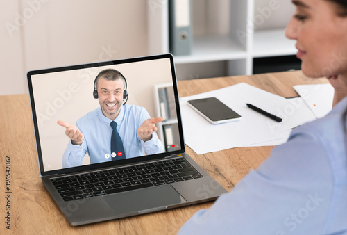 Young woman having conversation with service center representative online