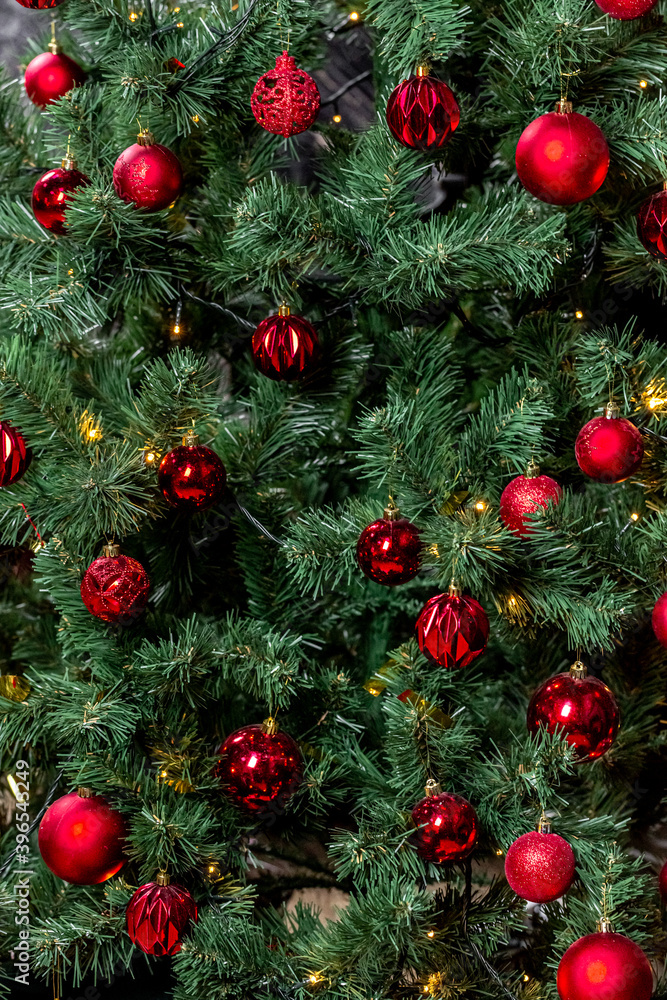Christmas tree with garlands and red balls in the living room, beautiful new year background Christmas tree with garlands and red balls in the living room, beautiful new year background